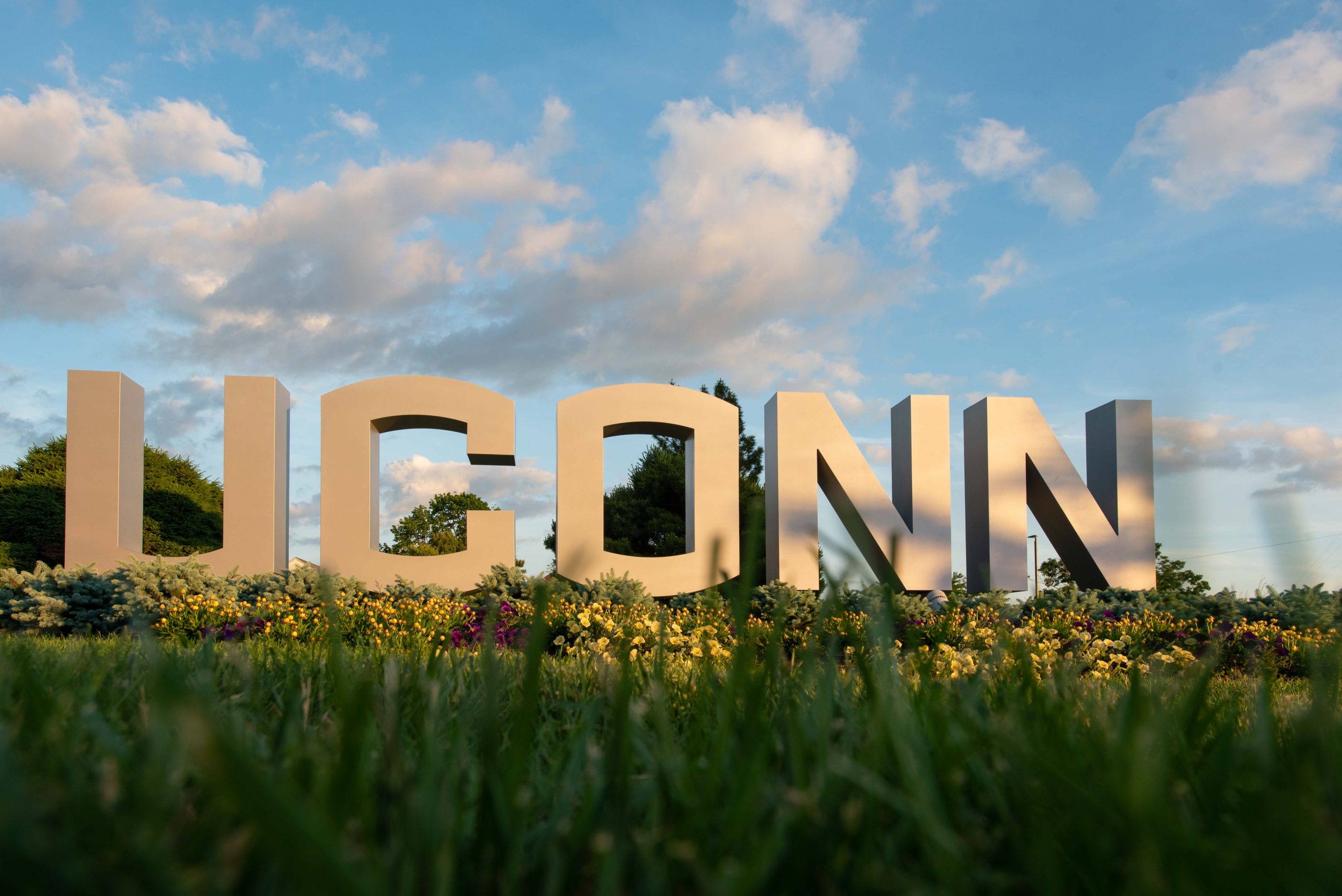 File photo: UConn’s large letter sign at dusk on June 12, 2021.