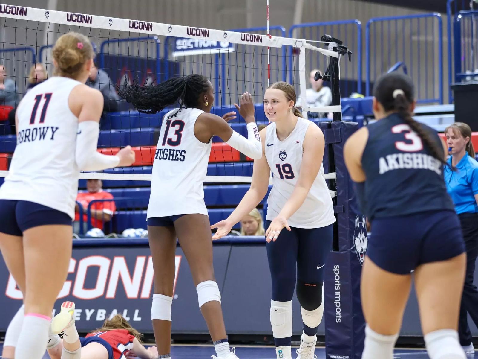 UConn volleyball players during the Seton Hall match covered by the official recap.