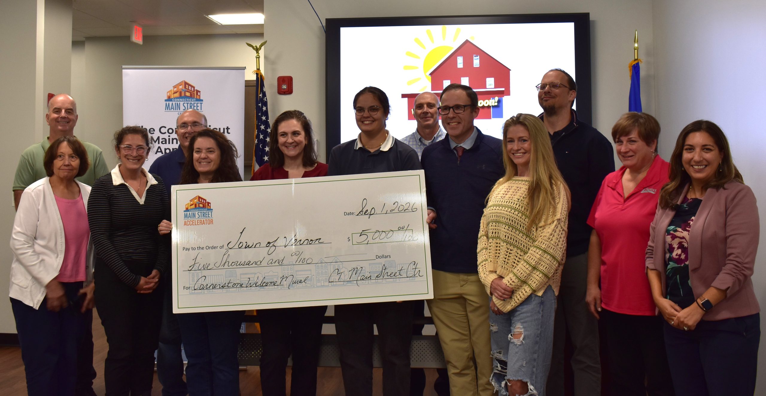 Grant-presentation photo supplied with Connecticut Main Street Center’s October 13, 2026 announcement of Vernon’s $5,000 Threads of Community welcome-mural grant. The photo’s capture date is not verified.